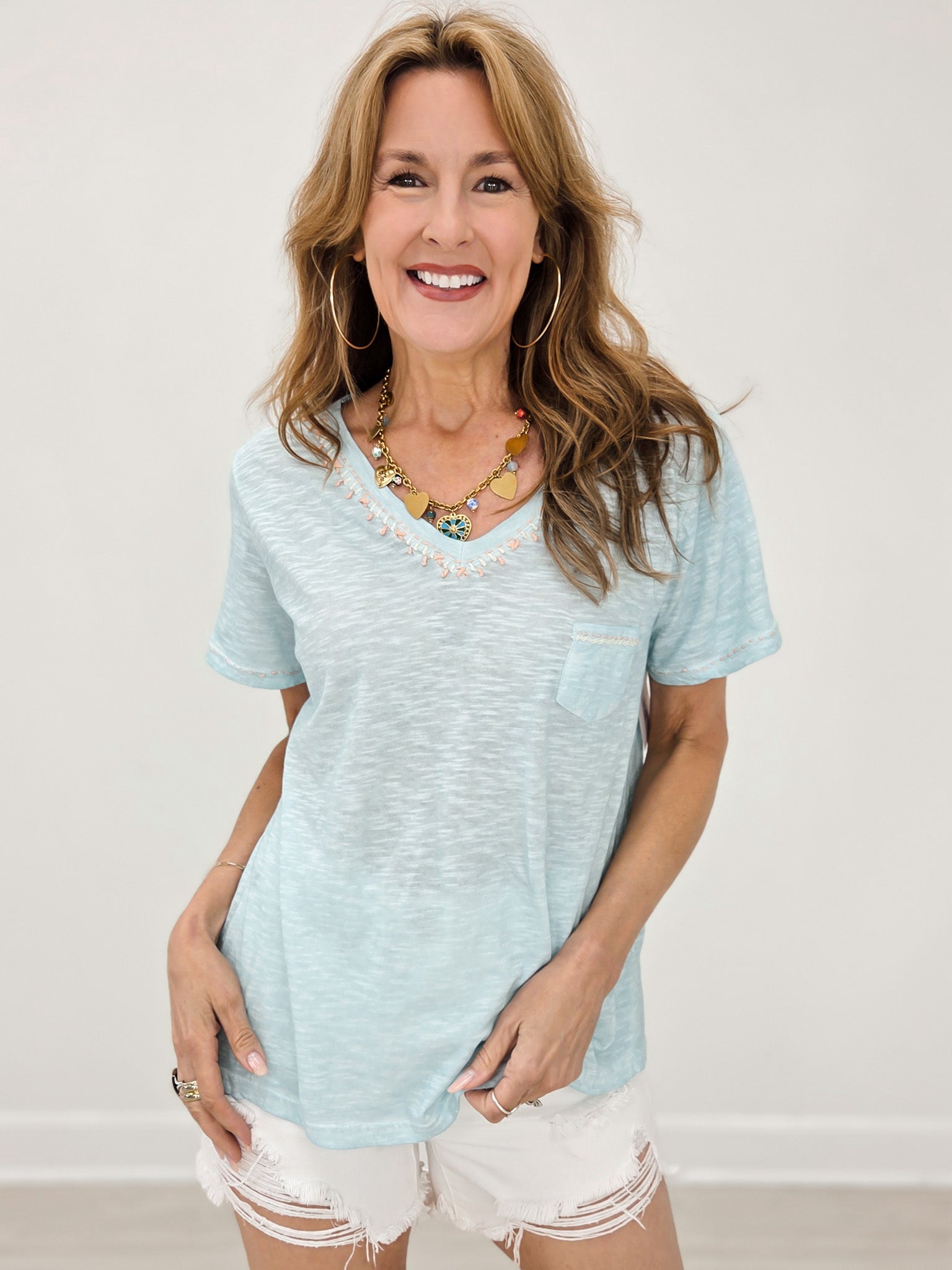 Short Sleeve Knit Shirt With A V-Neck Accented by Hand Stitch Detailing