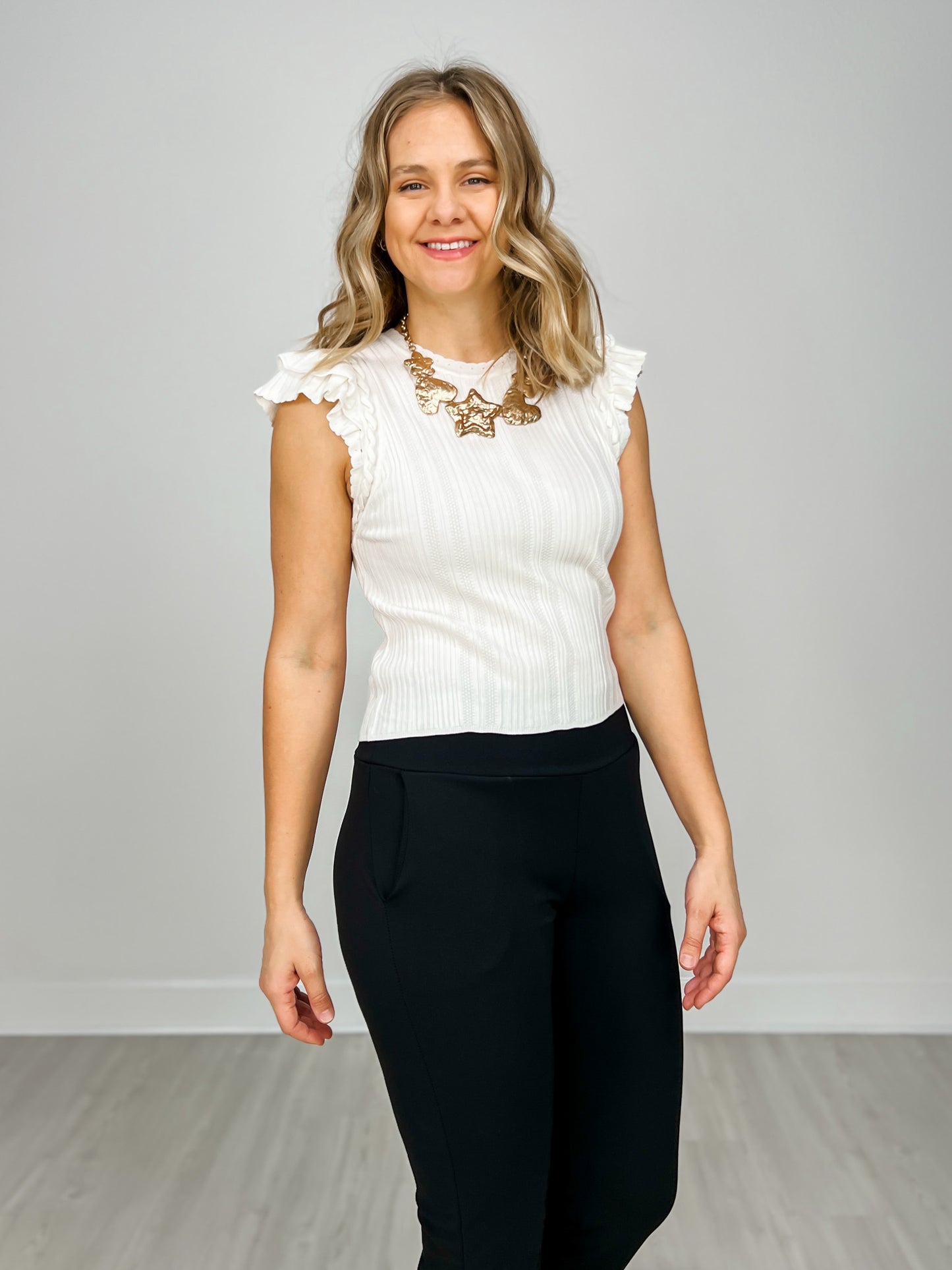 Ruffled Sleeveless Ribbed Knit Top