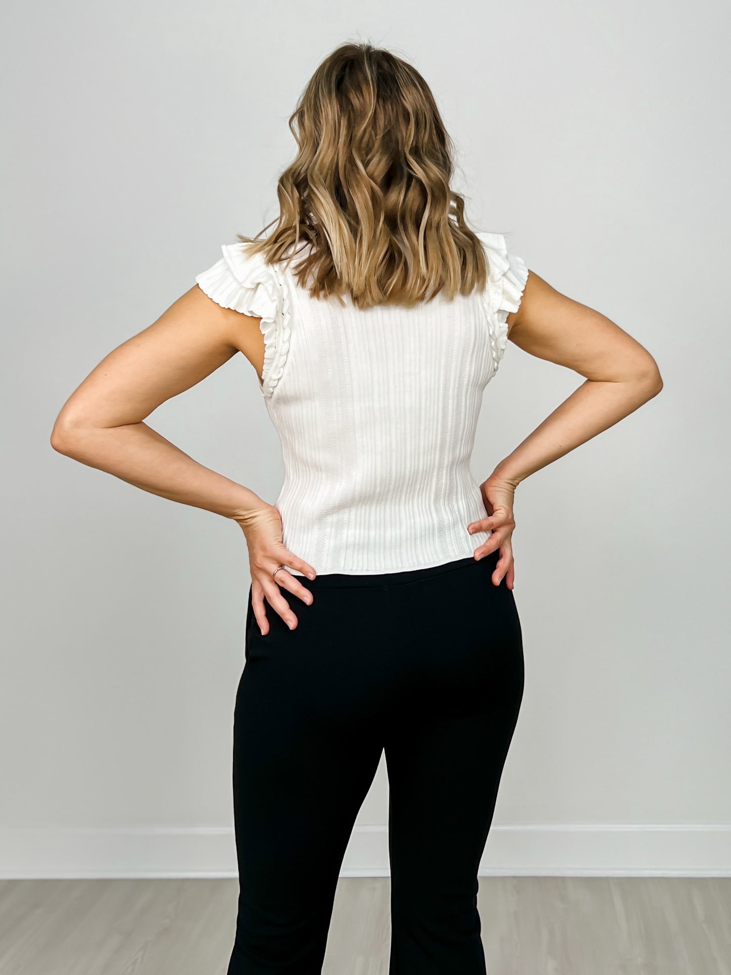 Ruffled Sleeveless Ribbed Knit Top