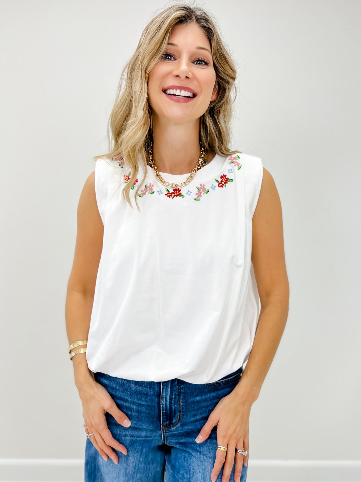 Sleeveless Knit Top With A Floral Embroidered Neckline and Gathered Bubble Hem