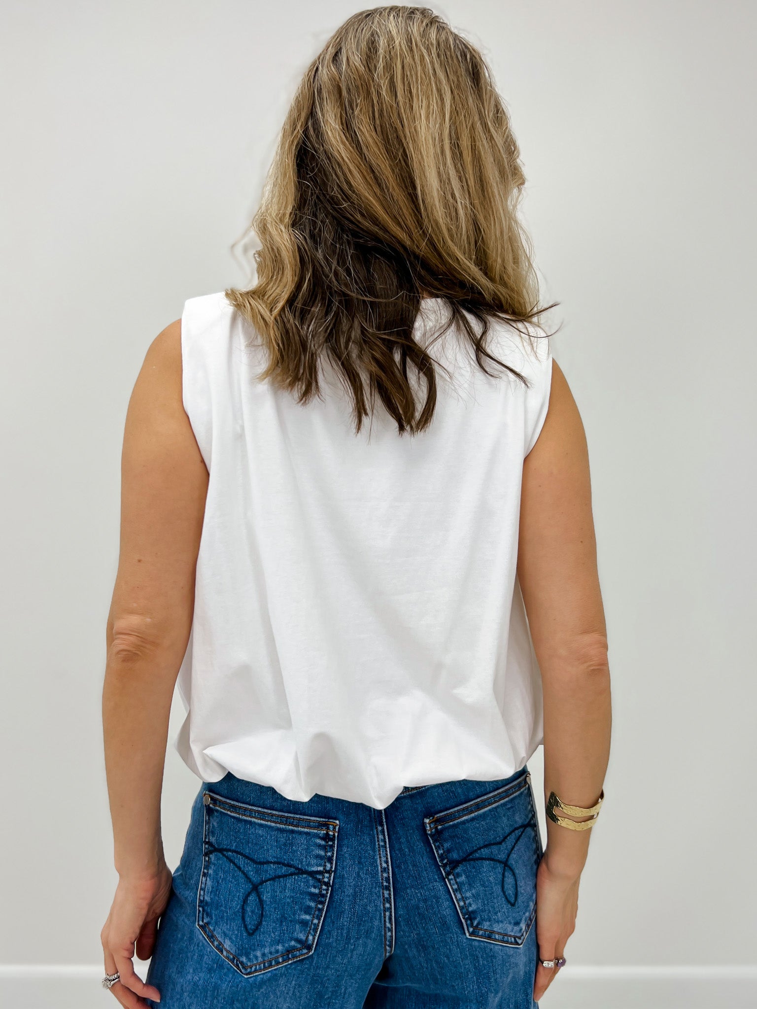 Sleeveless Knit Top With A Floral Embroidered Neckline and Gathered Bubble Hem