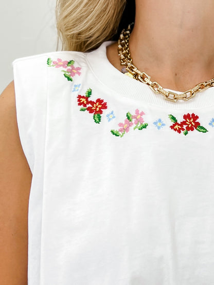Sleeveless Knit Top With A Floral Embroidered Neckline and Gathered Bubble Hem